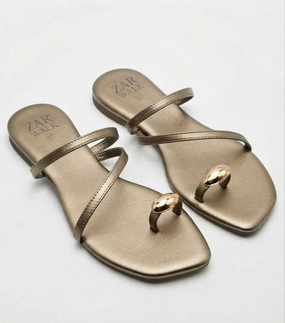 Golden women’s metallic strappy flat sandals